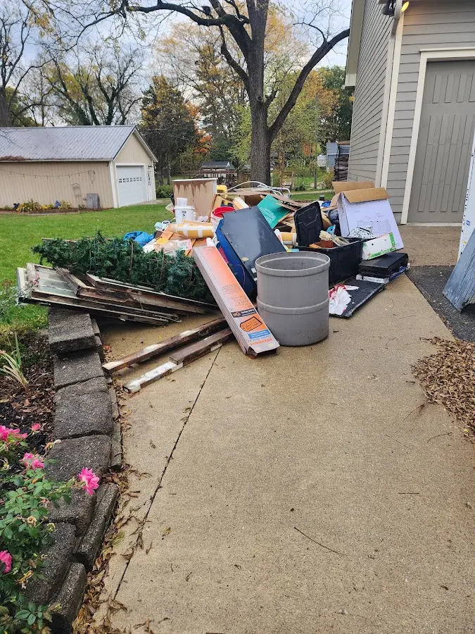 Dumpster being loaded with debris for 3 Yard Dumpster Rental in Five Forks